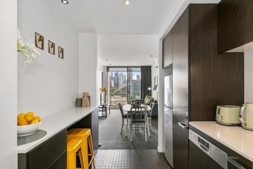 a kitchen with a counter and a dining room at East Melb 2bed parking pet friendly in Melbourne