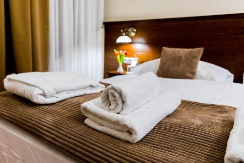 a hotel room with two towels on a bed at Hotel Bankov Košice in Košice