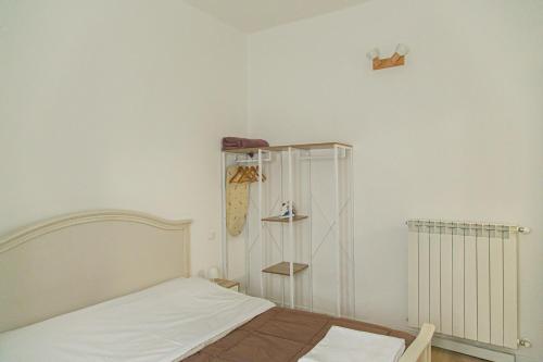 a small bedroom with a bed and a closet at Alla Fiera apartment in Bergamo