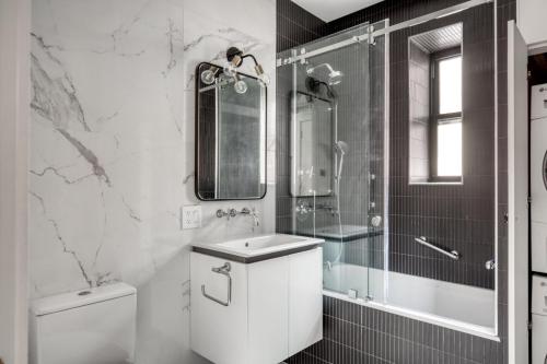 a bathroom with a toilet and a sink and a shower at Brooklyn Heights 2br w elevator wd NYC-1066 in Brooklyn