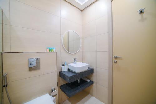 a bathroom with a sink and a mirror at New Contemporary 1BR Apt in Jumeirah Garden City in Dubai