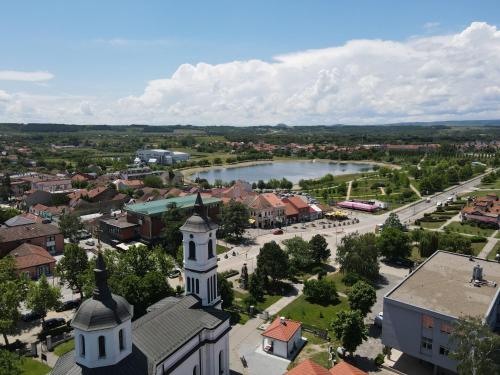 an aerial view of a town with a church and a river at Apartment DIANA in Kladovo