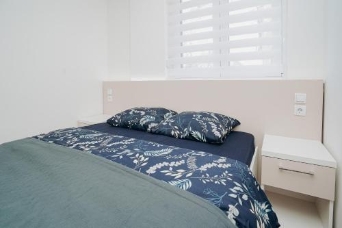 a bedroom with a bed with a pillow on it at Apartment DIANA in Kladovo
