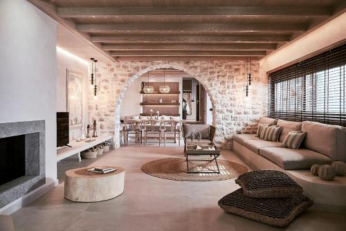a living room with a couch and a fireplace at The Sand Villa in Agios Nikolaos