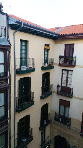 a building with balconies on the side of it at Pensión Manoli in Bilbao