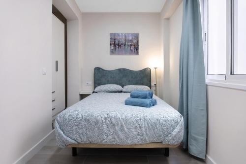 una camera da letto con un letto con cuscini blu di Apartamento en Casa telmo a Santa Cruz de la Palma