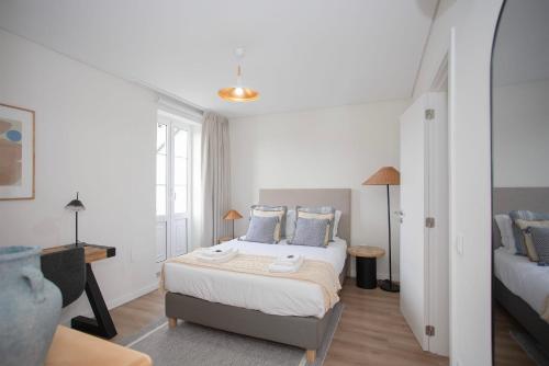 a bedroom with a bed with blue pillows at Liiiving in Porto - Downtown Quiet House in Porto