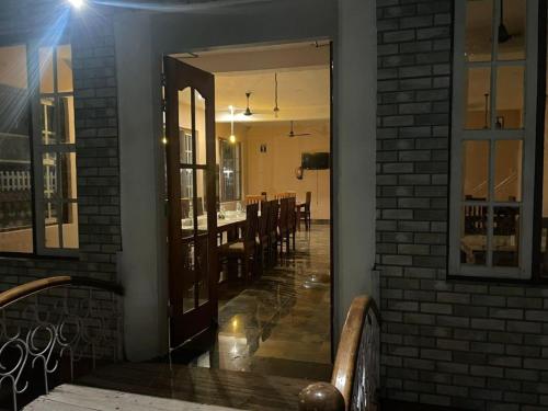 a dining room with a mirror and a brick wall at The Farmerian Resort in Belparāo