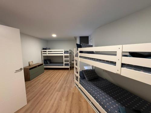 a room with two bunk beds and a desk at Alquilaencanarias El Faro Beach in El Médano