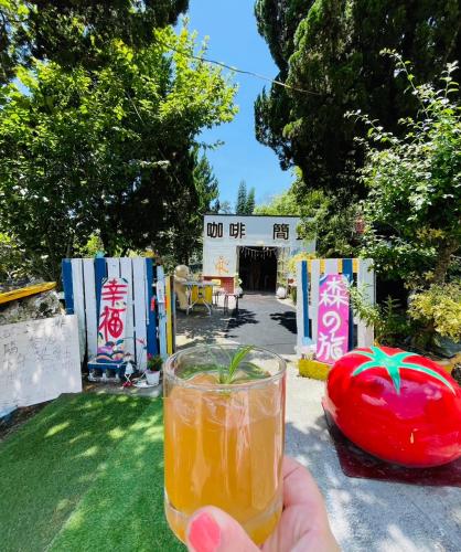 a person holding a drink in front of a stage at Shi Bi Hotel in Gukeng