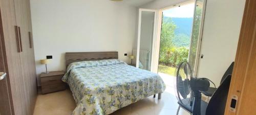 a bedroom with a bed and a large window at Antico Principato di Seborga in Vallebona