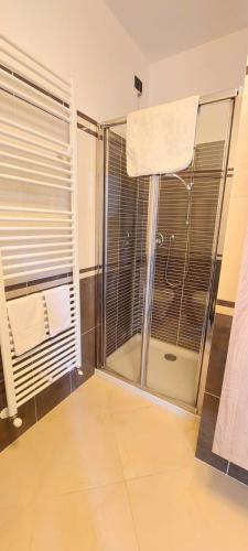 a bathroom with a shower with a glass door at Antico Principato di Seborga in Vallebona