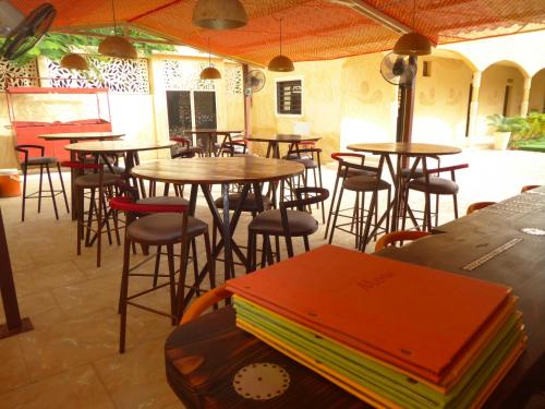 a group of tables and chairs in a restaurant at O Cupidon Doré in Saly Portudal