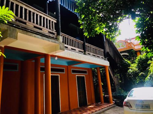 um edifício laranja com uma varanda em cima em Brightness Villa (Private Home Stay) em Phumĭ Poŭthĭ Mâ Srei