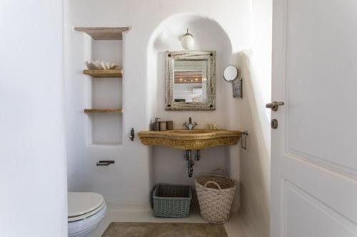 a bathroom with a sink and a toilet at Sea View Villa in Ornos in Ornos