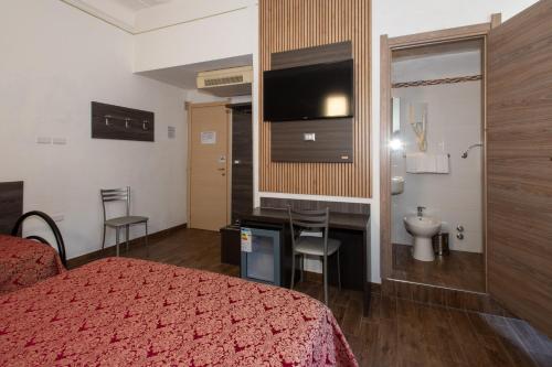 a hotel room with a bed and a bathroom at Hotel Piola in Milan
