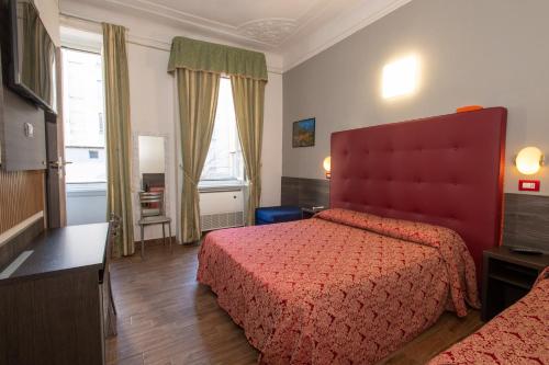 a bedroom with a red bed and a window at Hotel Piola in Milan