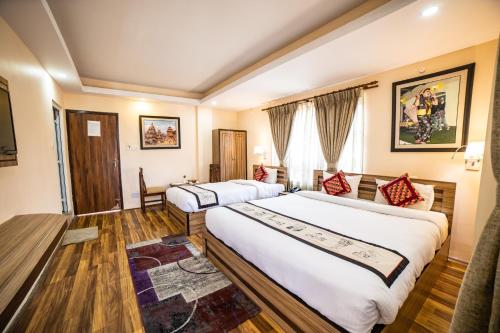 a hotel room with two beds and a window at Kathmandu Garden Home in Kathmandu