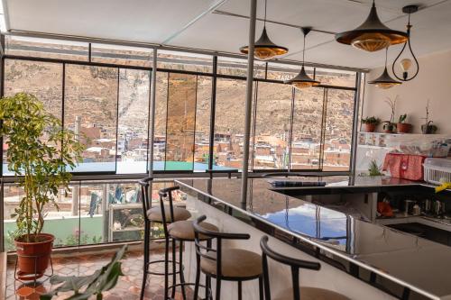 a bar with stools in a kitchen with a view at Montafé Mirador in Tarma