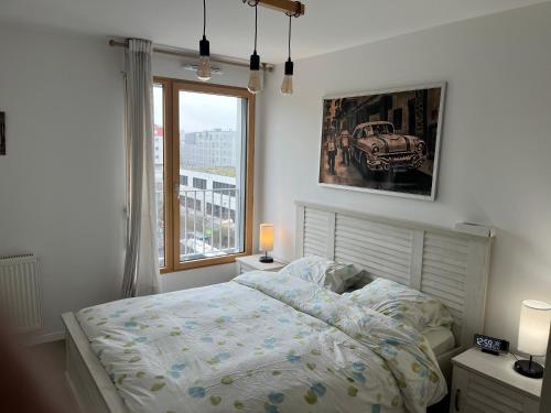 a bedroom with a bed and a window at 3 pièces à 4min du RER B in Saint-Denis