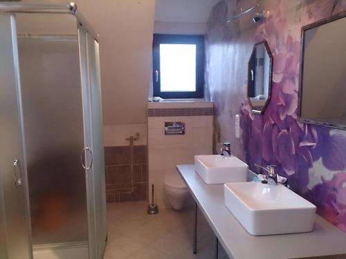 a bathroom with two sinks and a shower at Bea's Monteurzimmer in Seckach