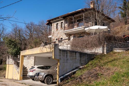 a car parked in a garage in front of a house at Margarita's House in Kalyvia Fylaktis