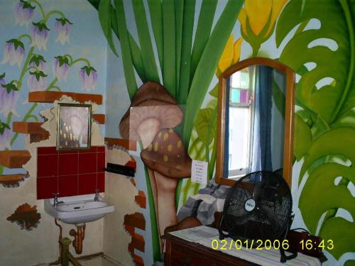 a bathroom with a painting of a mushroom and a sink at Kimberly Backpacker Hotel in Cape Town