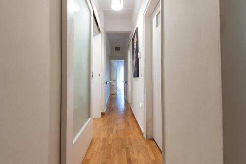 a hallway with white walls and a wooden floor at Houseloft CityView Hagia Sophia in Thessaloniki
