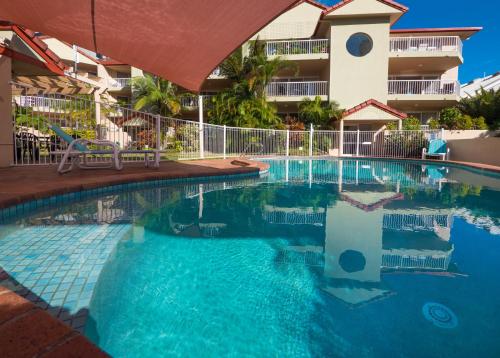 a swimming pool in front of a hotel at Jubilee Views Holiday Apartments in Gold Coast