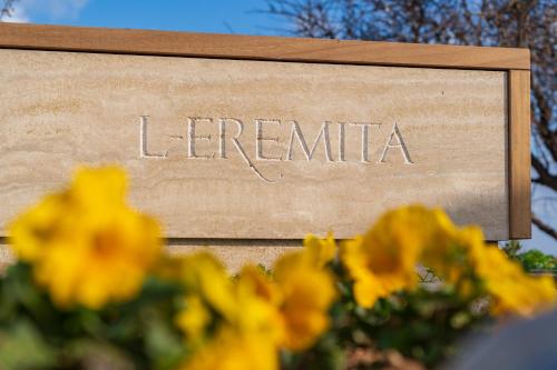 a sign with yellow flowers in front of it at L-Eremita Boutique Hotel in Qala