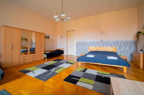 a bedroom with a bed and a rug at Tomka Apartman in Szeged