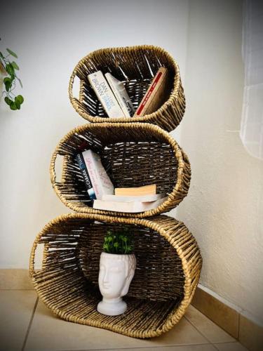 three wicker baskets with a vase and books at Depa en el corazón de Guanajuato in Guanajuato