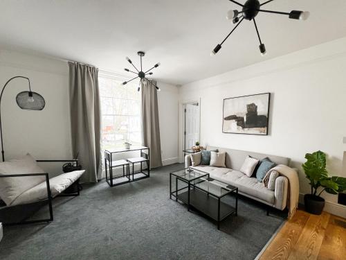 a living room with a couch and a table at Stunning City Apartment - Parking 