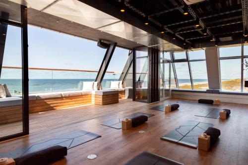 an empty room with a view of the ocean at Wyn. Strandhotel Sylt in Westerland (Sylt)
