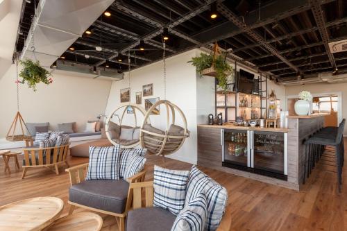 a living room with a couch and a table at Wyn. Strandhotel Sylt in Westerland (Sylt)