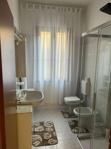 a bathroom with a sink and a toilet and a shower at Casa di Fati in Mestre