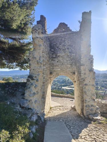 an old stone building with an arch on a hill at Plus Belle La Vue Allauch in Allauch