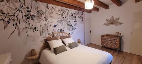 - une chambre avec un lit et une fresque murale aux fleurs dans l'établissement Des Histoires d'Anges - Le gîte, à Tournus