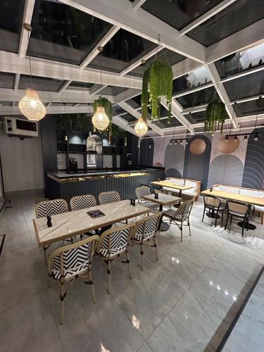 a dining room with tables and chairs and lights at Mona Bosphorus in Istanbul