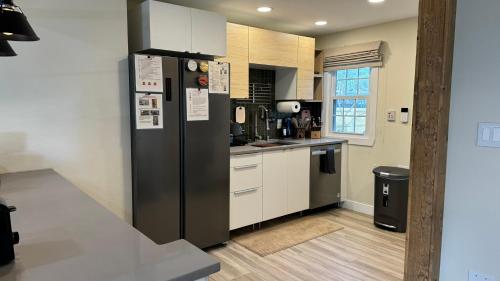 a kitchen with a large black refrigerator in a room at Garden District Duplex in Baton Rouge