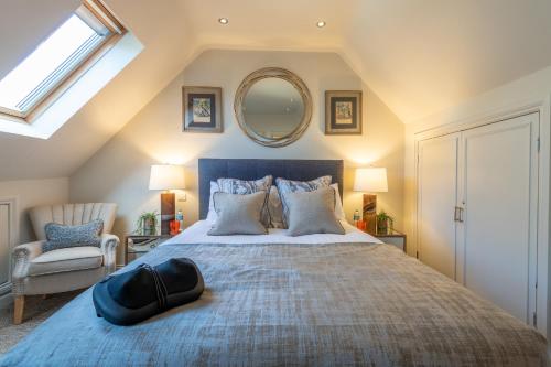 a bedroom with a large bed and a mirror at 5-STAR LUXURY on MILLSTREAM near SEA, OLD BOSHAM in Bosham