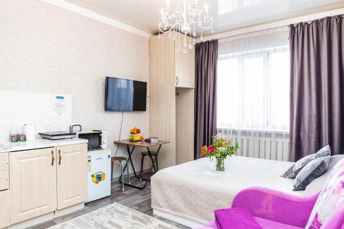 a small room with a bed and a table at YourHouse Микрорайон Жетысу-2, дом 66 in Almaty