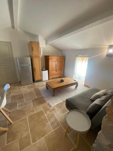 a living room with a couch and a table at Le Mas Vivarés in Lablachère