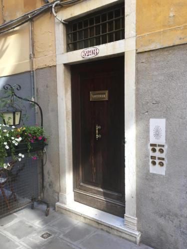 a door to a building with a sign on it at San Bortolomio near Suso Ice-cream in Venice
