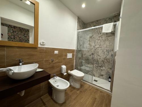 a bathroom with a sink and a toilet and a shower at Eden LUXURY ROMA in Rome