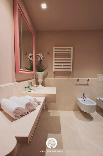 a bathroom with a sink and a toilet and a tub at Officina del Sole in Montegiorgio