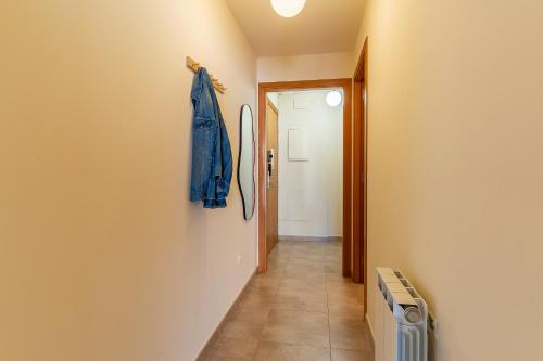a hallway with a blue jacket hanging on a wall at AB Sagrada Familia - Sant Pau in Barcelona