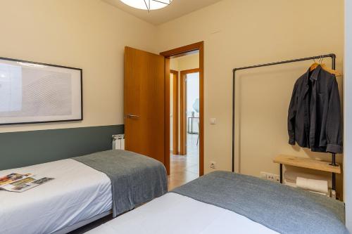 a bedroom with two beds and a closet at AB Sagrada Familia - Sant Pau in Barcelona