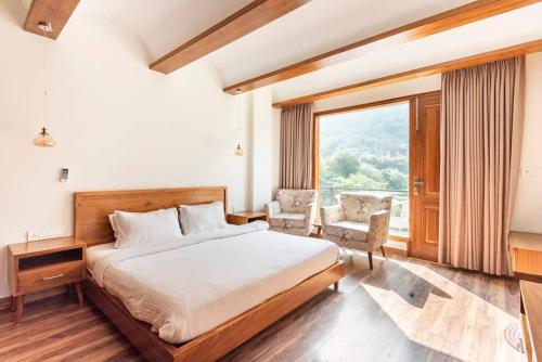 a bedroom with a bed and a large window at French Villa I Luxury I 3BHK Villa I Kasauli I 87oo2o5865 in Kasauli