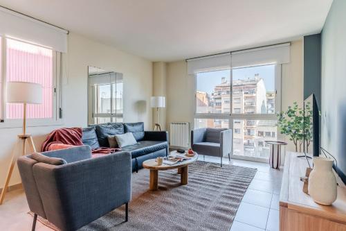 a living room with a couch and a table at AB Sagrada Familia - Sant Pau in Barcelona